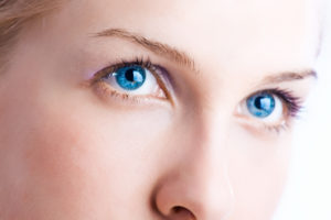Close up portrait of a person with bright blue eyes.