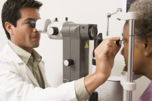 Eye Doctor giving a patient an eye Exam.