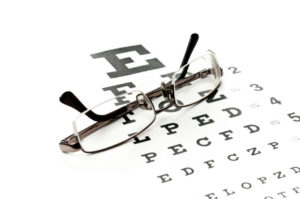 Eye glasses lying on top of an eye exam