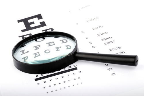 A magnifying glass over a routine eye test.