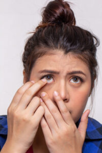 person putting specialty contact lenses into their eye