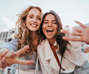 Two women posing for picture